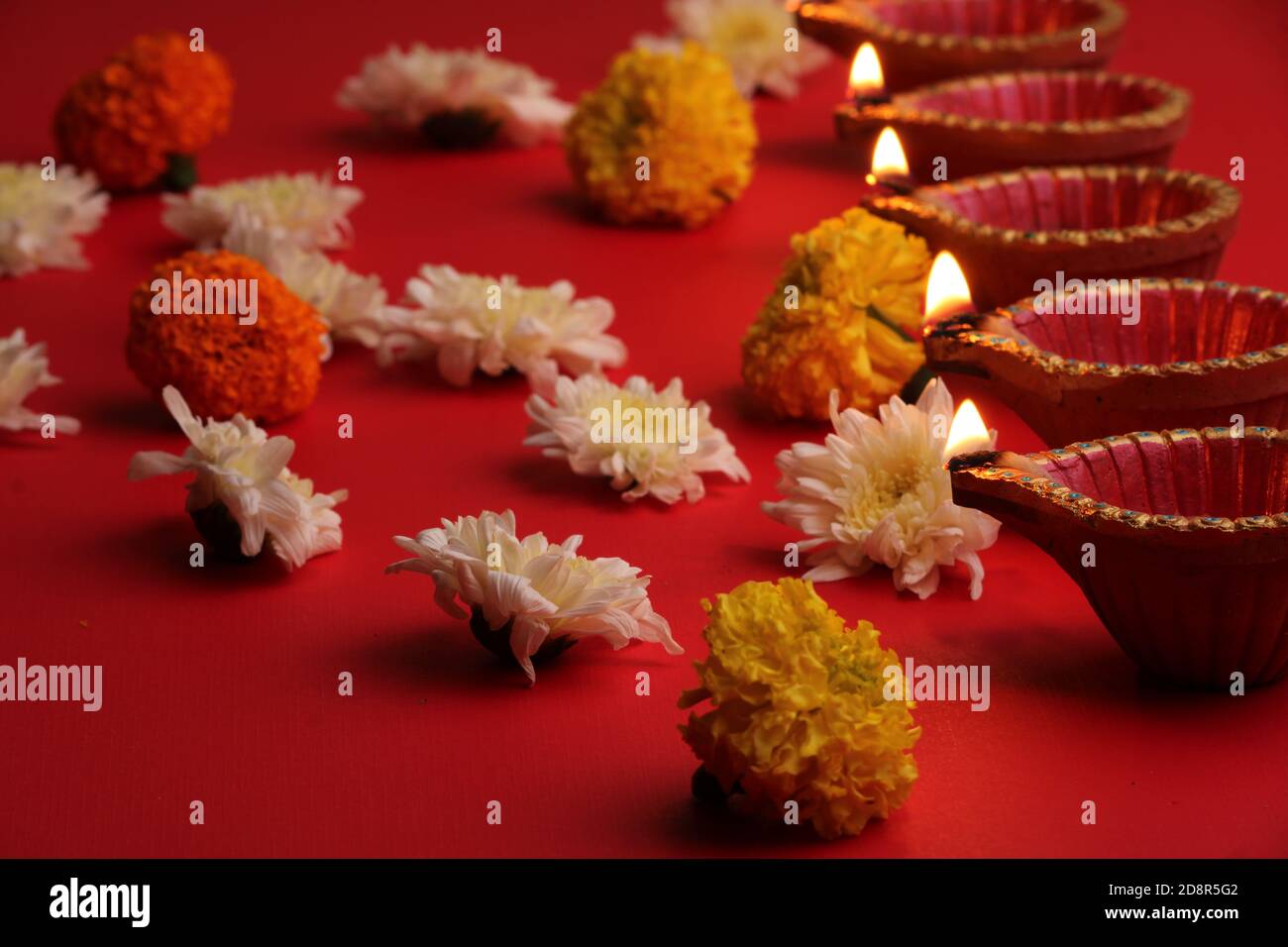diya Lampen beleuchtet während diwali Feier mit Blumen Stockfoto