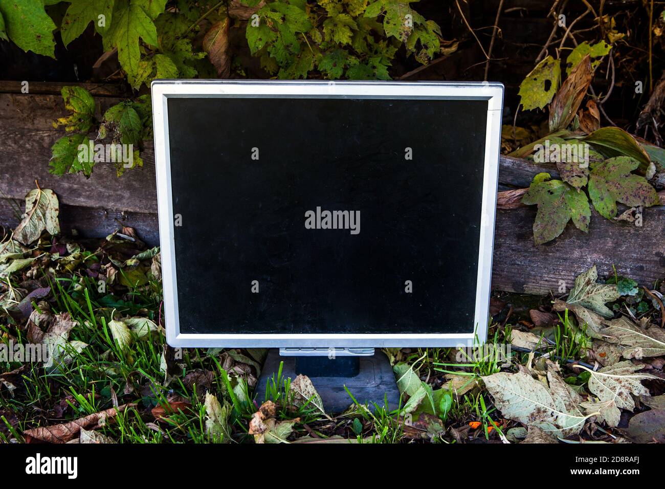 Alte und schmutzige Computer-Monitor auf dem Boden im Freien Stockfoto