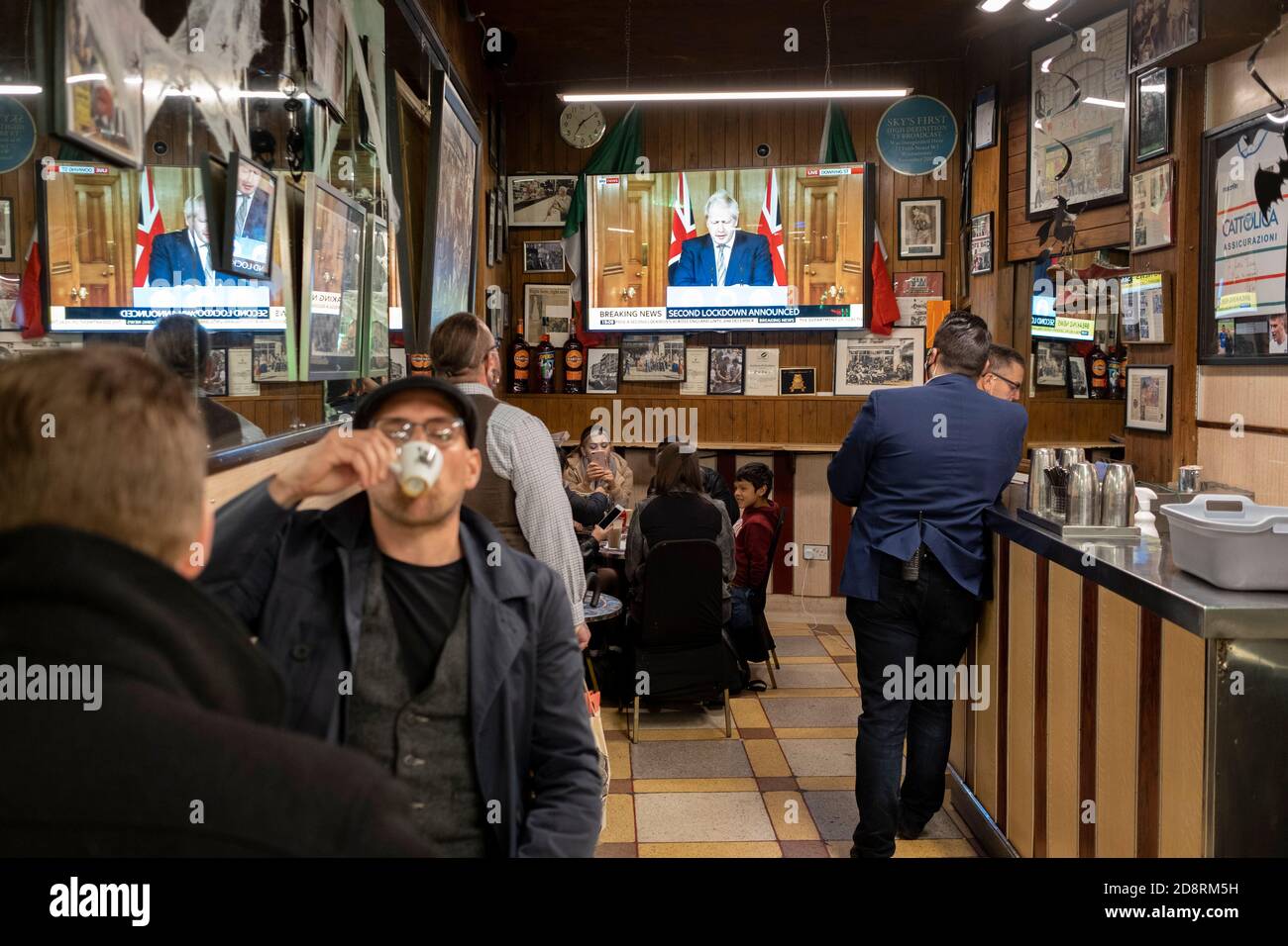 Auf einem Fernsehbildschirm in Bar Italia, dem berühmten italienischen Café in Soho, spricht Premierminister Boris Johnson Großbritannien im Live-Fernsehen an, um eine zweite landesweite Sperre während der zweiten Welle der Coronavirus-Pandemie am 31. Oktober 2020 in London, England, anzukündigen. Unternehmen wie die Bar Italia müssen bis auf Takeaways wieder geschlossen werden, und zwar ab Mitternacht am Donnerstag für einen Zeitraum von einem Monat. Stockfoto