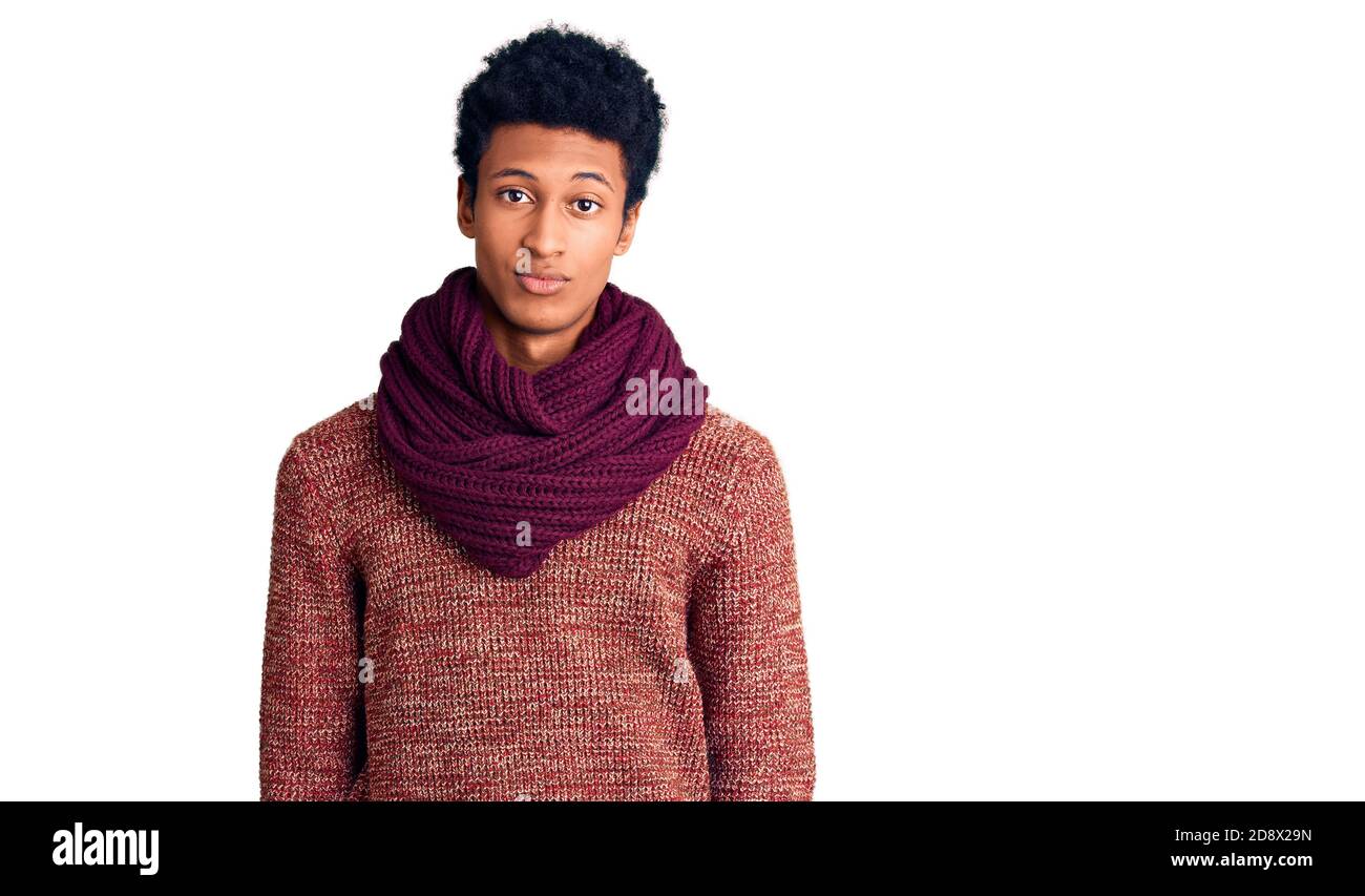 Junger afroamerikanischer Mann in lässigem Winterpullover und Schal sieht schläfrig und müde aus, erschöpft von Müdigkeit und Kater, faule Augen am Morgen Stockfoto