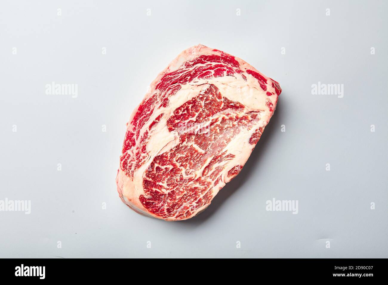 Rrib Eye Steak aus marmorierten Getreide gefüttert Rindfleisch liegt auf einem weißen Hintergrund. Marmorbeef Blick von oben Stockfoto