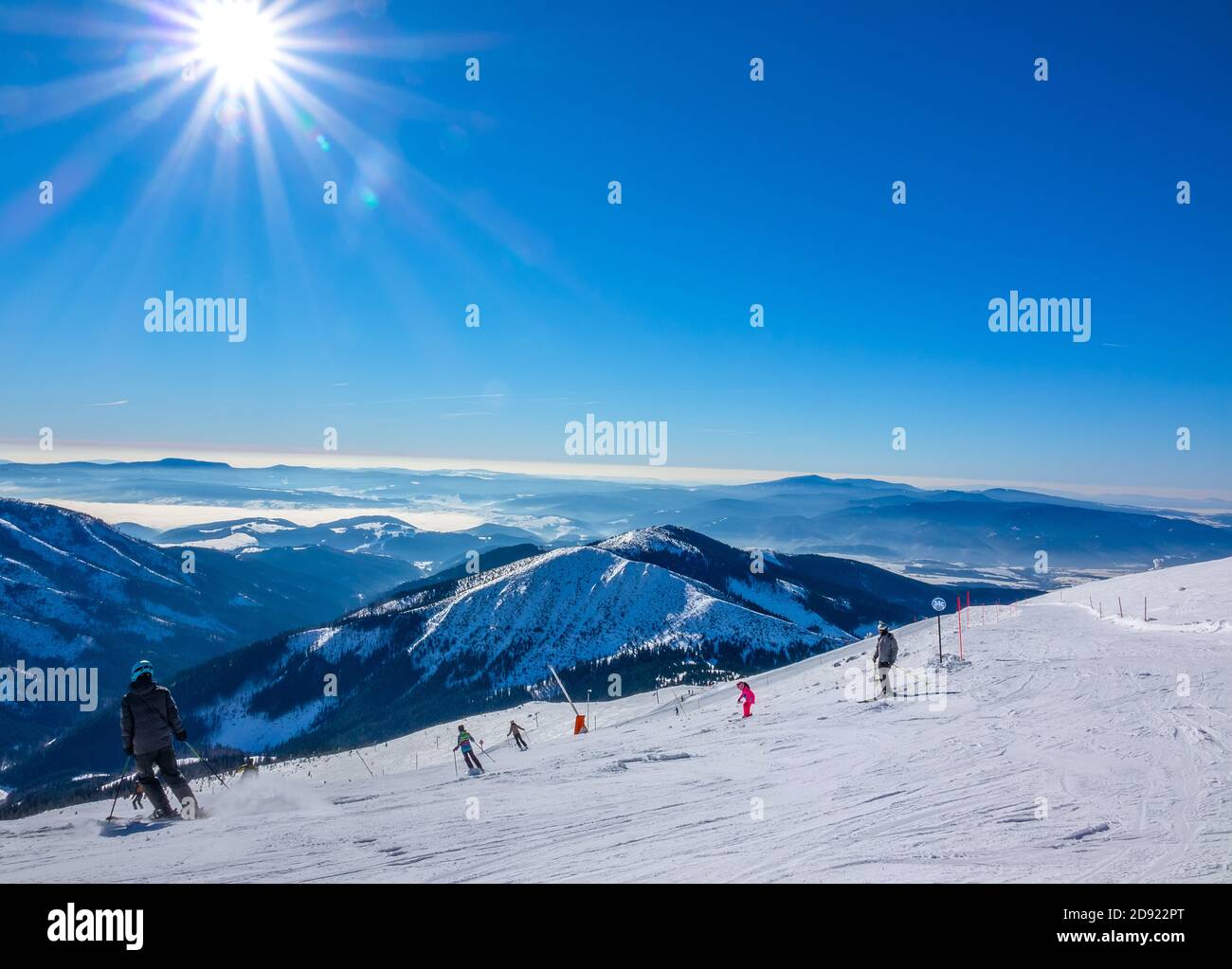 Skigebiet Jasna im Winter Slowakei. Panoramablick von der Spitze der schneebedeckten Berge und Skipiste mit Skifahrern Stockfoto