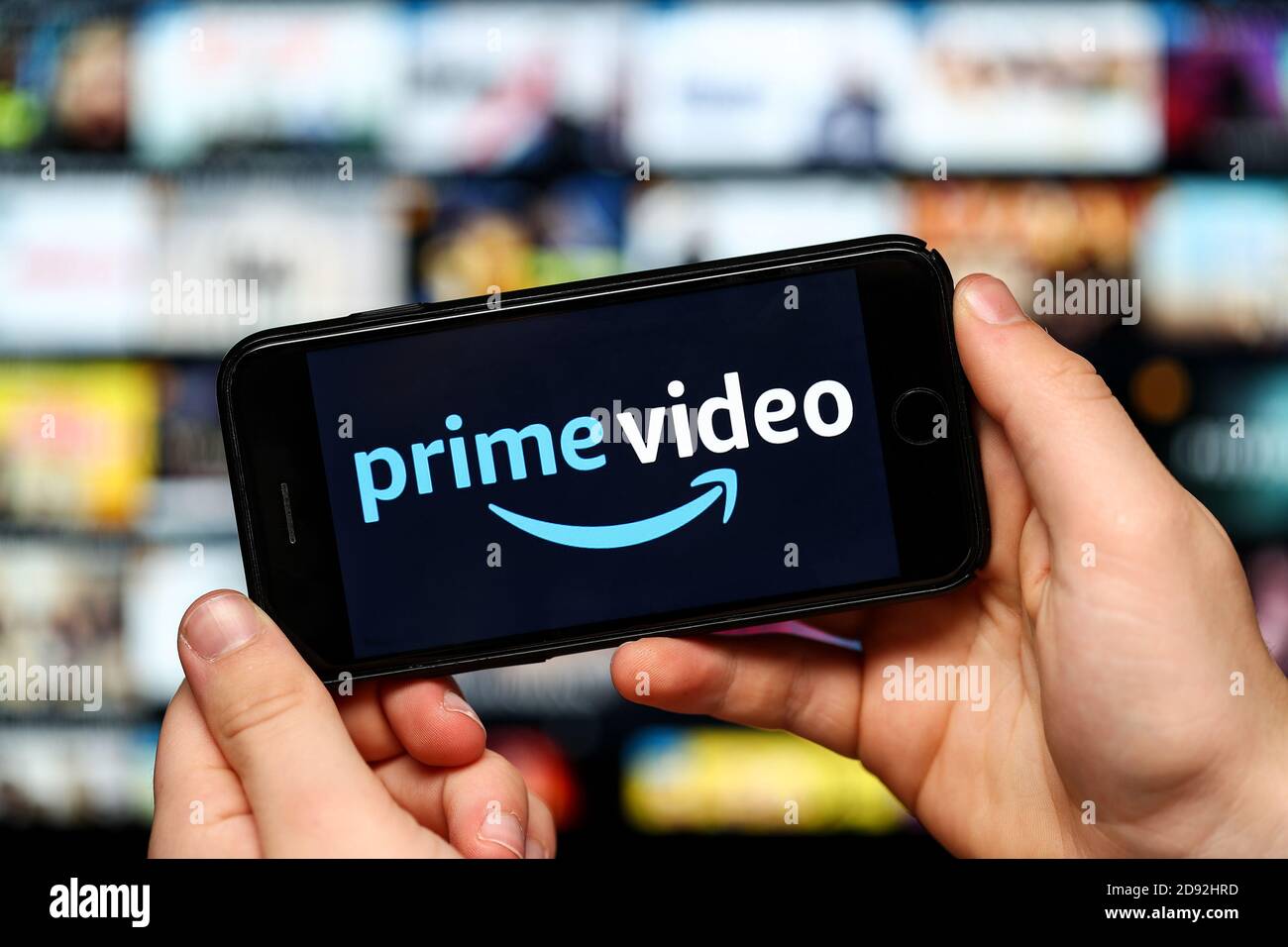 Ein Teenager, der Amazon Prime Video auf einem Mobiltelefon ansieht Und Computer Stockfoto