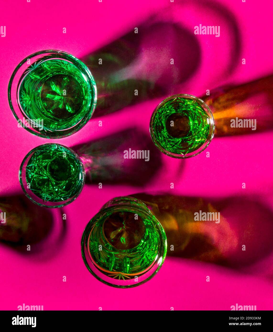 Starker Alkohol. Schnapsgläser mit Absinth auf rosa Hintergrund Stockfoto