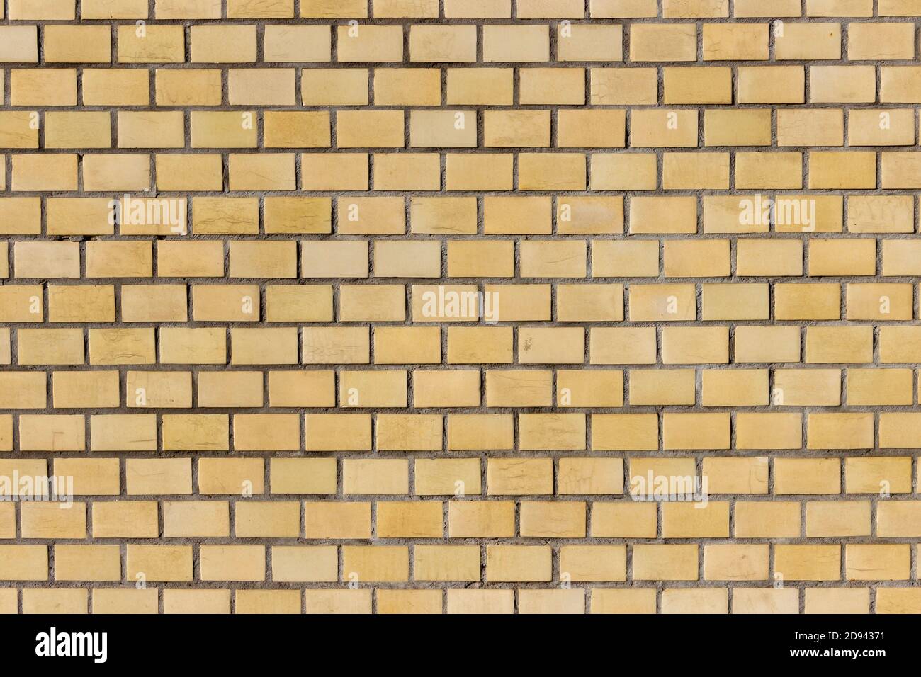 Oberfläche einer gelben Ziegelwand. Stockfoto