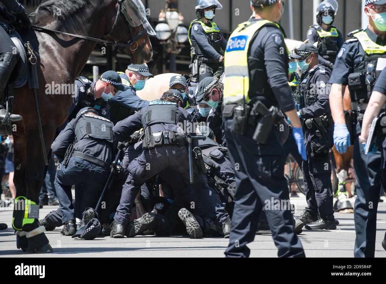 Melbourne, Australien, 03. November 2020, Eine Gruppe von Polizisten kämpft mit einem Mann auf dem Boden, während sie versuchen, ihn mit Handschellen zu fesseln, nachdem sie letzte Maßnahmen ergriffen haben, um den Protest zu beenden und alle Demonstranten im Landtagsparlament während einer weiteren Freedom Day Demonstration am Melbourne Cup Day mit der Forderung nach der Plünderung von Premier Daniel Andrews zu beschießen Über Lockdown Gesetze. Kredit: Michael Currie/Alamy Live Nachrichten Stockfoto