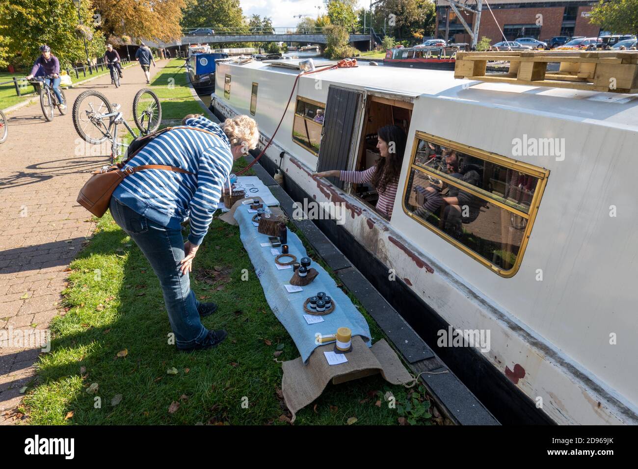 Lady verkauft handgemachte Kerzen von ihrem Kanalboot an Der Treidelpfad Stockfoto