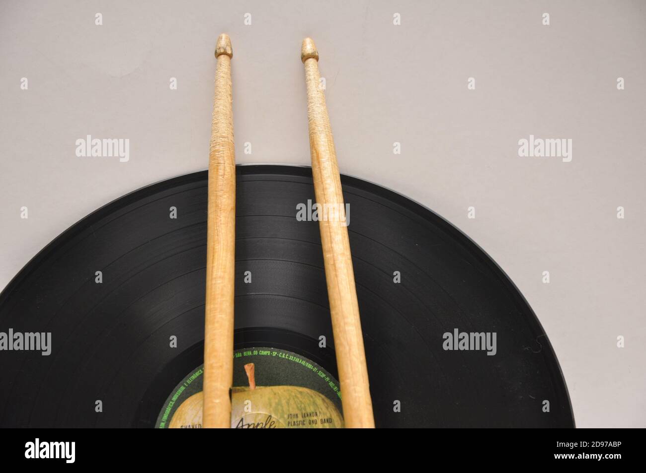 Vinyl-Schallplatte, mit Holztrommelstäben, die vom Gebrauch abgenutzt sind, Makrofoto, Draufsicht, weißer Hintergrund, Brasilien, Südamerika Stockfoto
