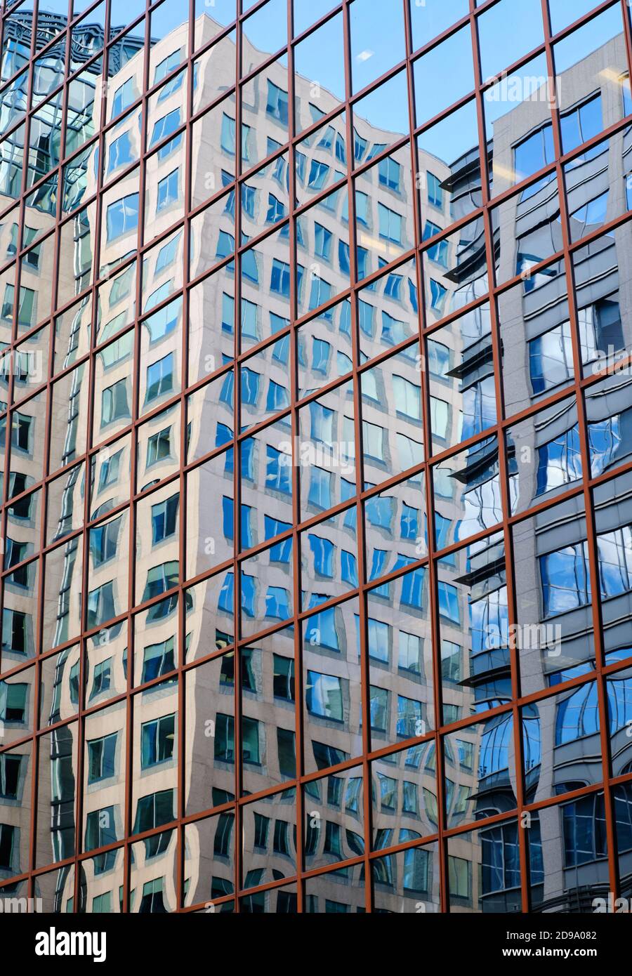 Gebäudehautreflektionen auf einem Gebäude aus quadratischen Fensterscheiben Wie Spiegel Stockfoto
