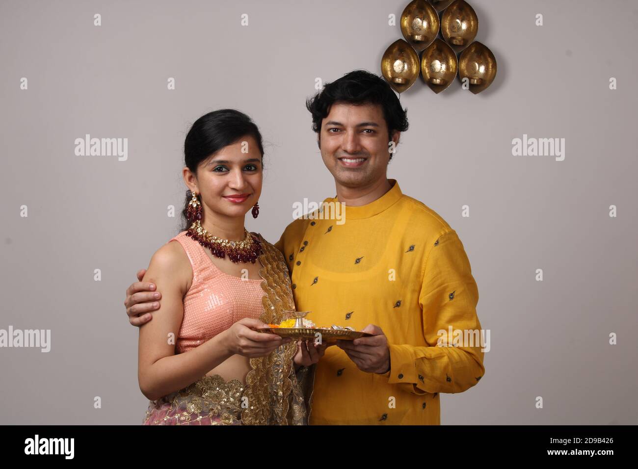 Nettes Paar hält Puja thali. Stockfoto