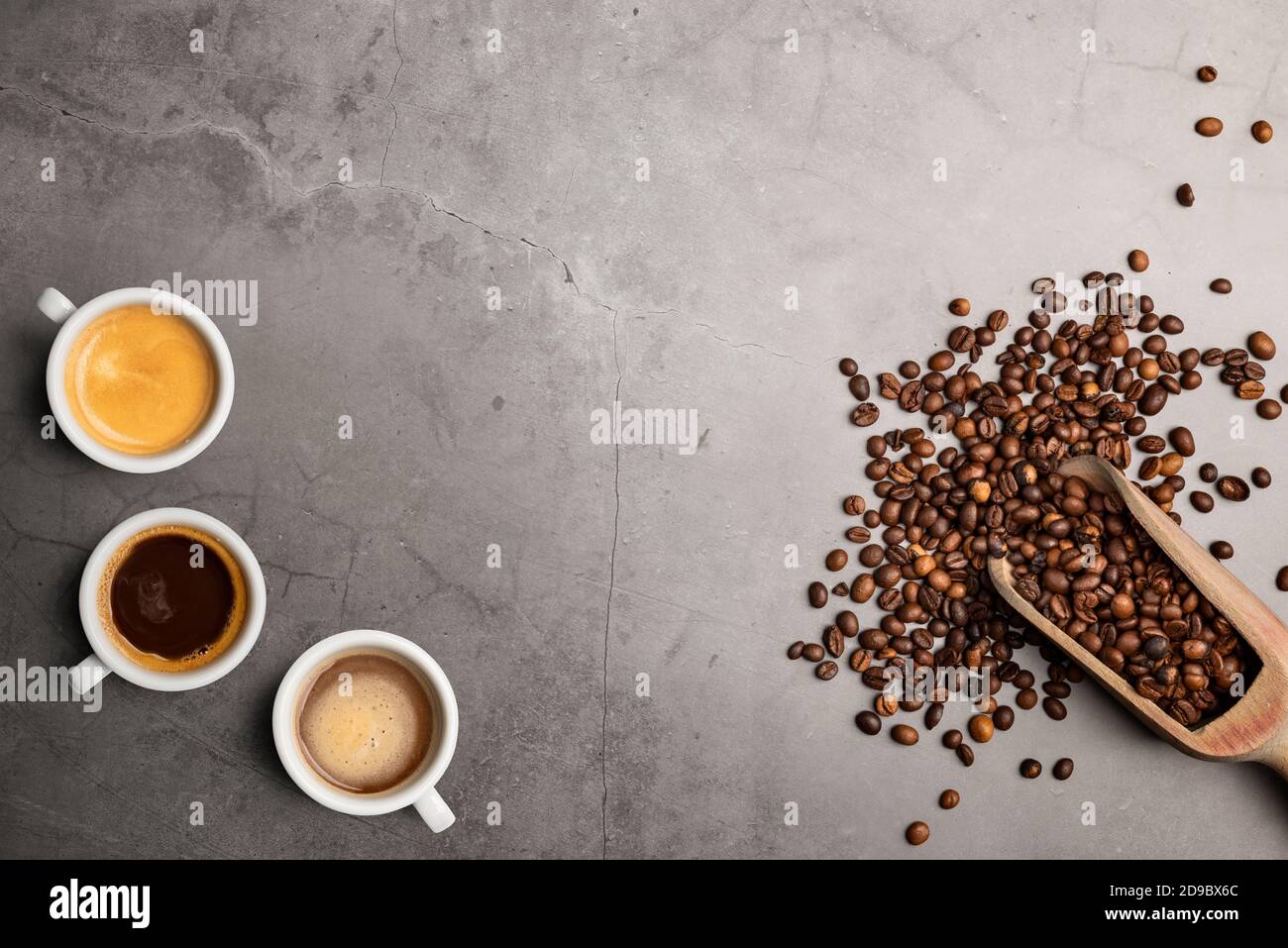 Auswahl an Kaffeetassen von oben mit Bohnen auf Stein Tabelle Stockfoto