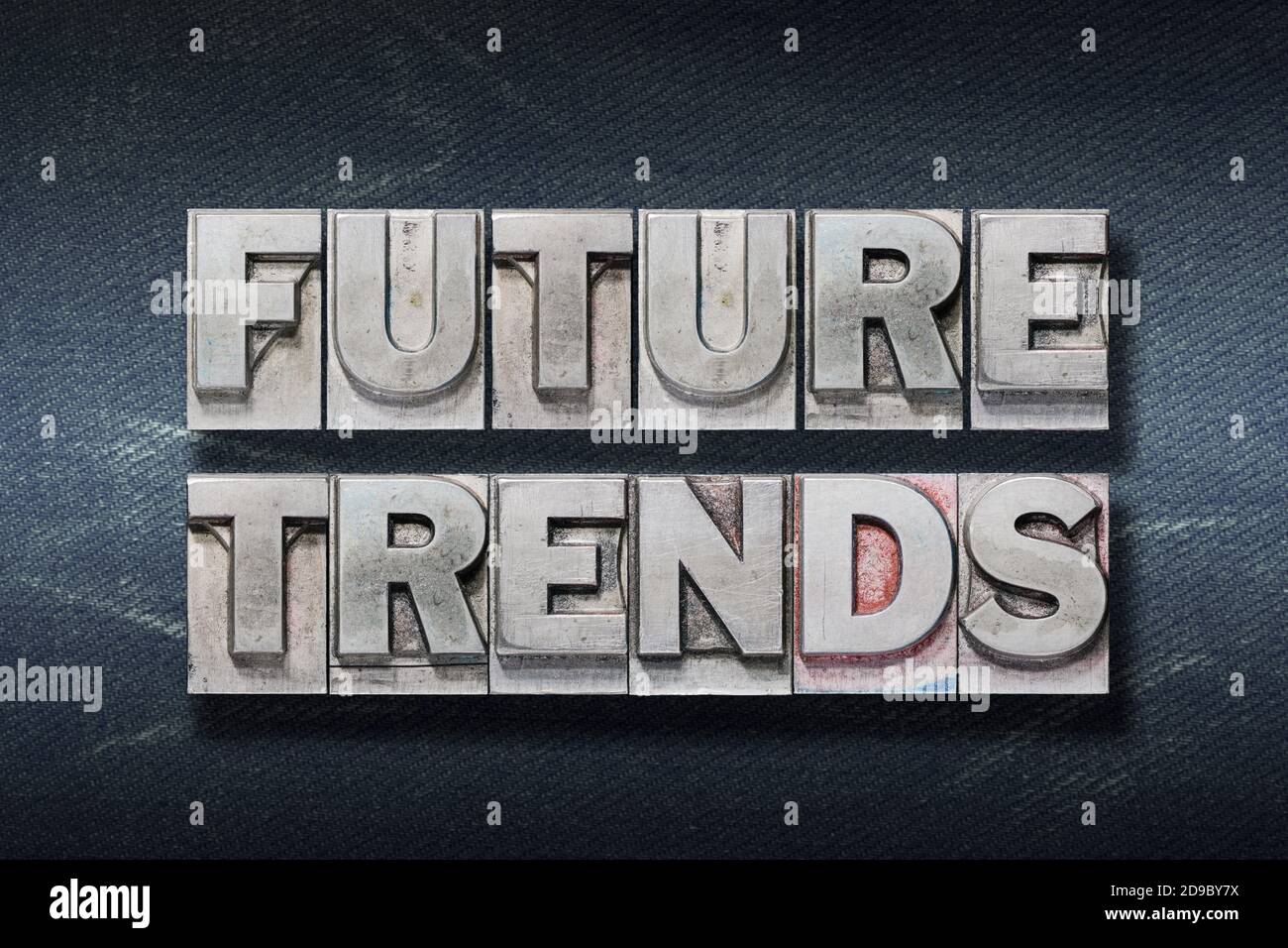 Future Trends Wort aus Metallic-Buchdruck auf dunklen Jeans Hintergrund Stockfoto