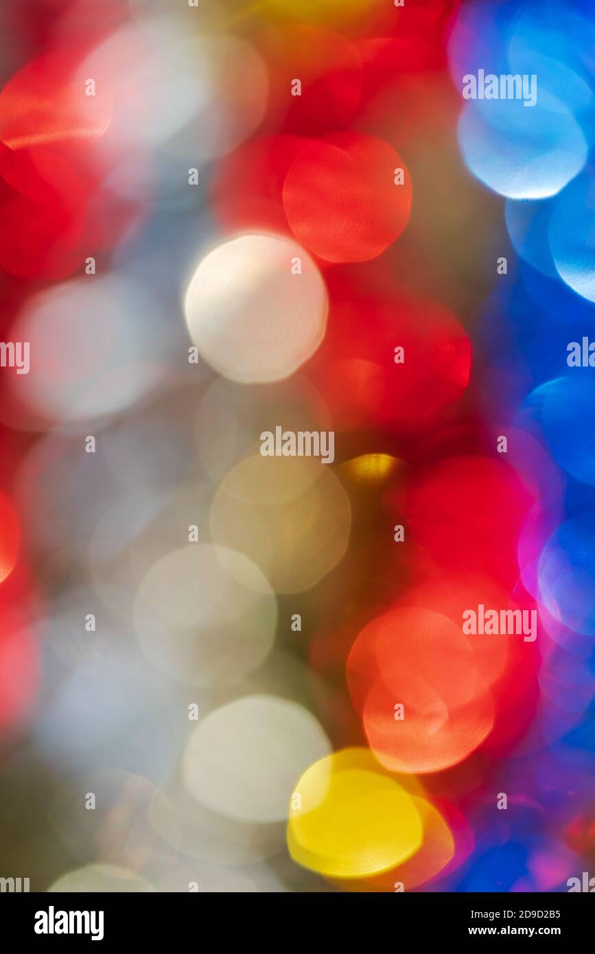 Defokussierte leuchtende Lichter, farbenfrohe abstrakte, unscharfe Bokeh-Hintergründe, lebendige Bewegungsunschärfe. Lichteffekte mit Lichtreflexionen, die nicht im Fokus stehen Stockfoto