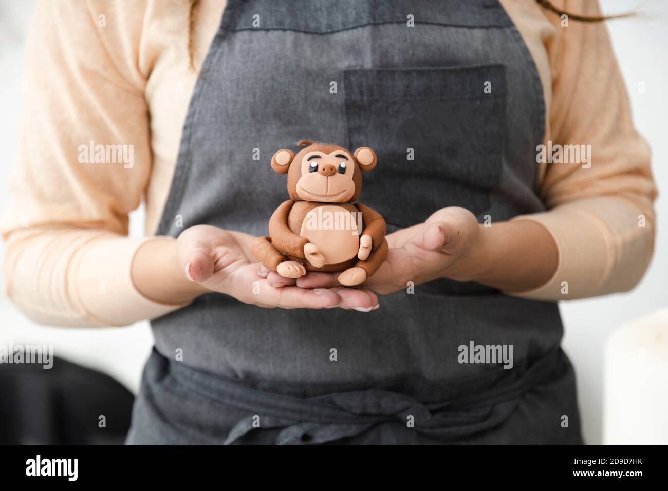 Nahaufnahme stolze junge Frau in ihrer Konditorei - Frau mit Fondant oder Tonskulptur in ihrer Kuchenwerkstatt - unternehmungslustige hispanische Frau - junge Wom Stockfoto