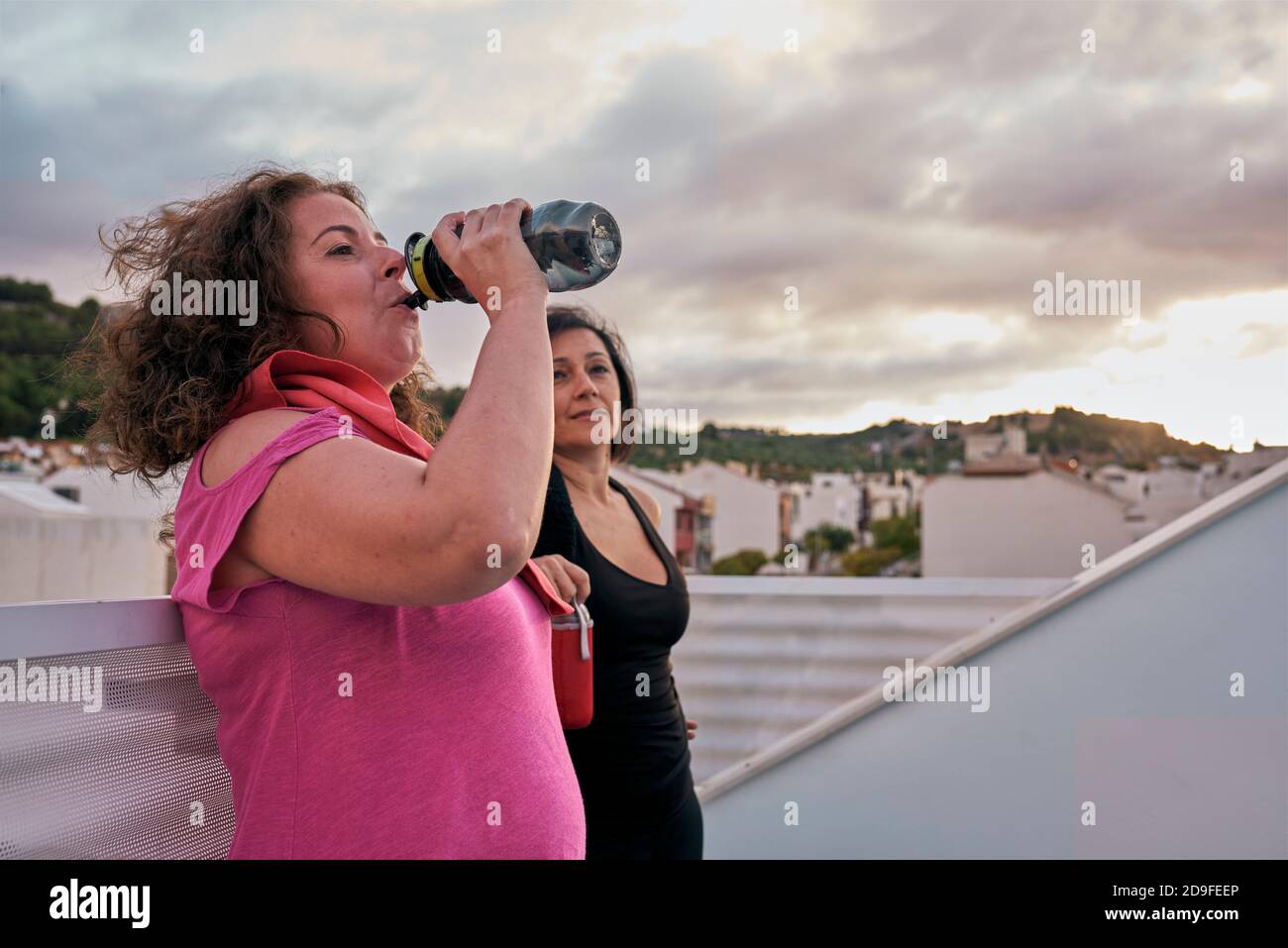 Zwei Frauen mit echten Körpern trinken Wasser aus ihrem wiederverwendbaren Flaschen Stockfoto Zwei Frauen mit echten Körpern trinken Wasser aus ihrem wiederverwendbaren Flaschen Stockfoto