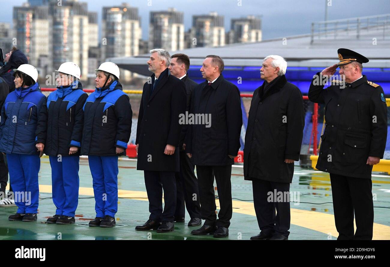 St. Petersburg Gouverneur Alexander Beglov, Mitte, Vorsitzender der United Shipbuilding Corporation Georgy Poltavchenko, rechts, und andere Beamte stellen sich für eine Flaggenanhebung Zeremonie an Bord des neuen Diesel-elektrischen Eisbrechers Viktor Chernomyrdin dockte an der Admiralty Shipyard 3. November 2020 in St. Petersburg, Russland. Stockfoto