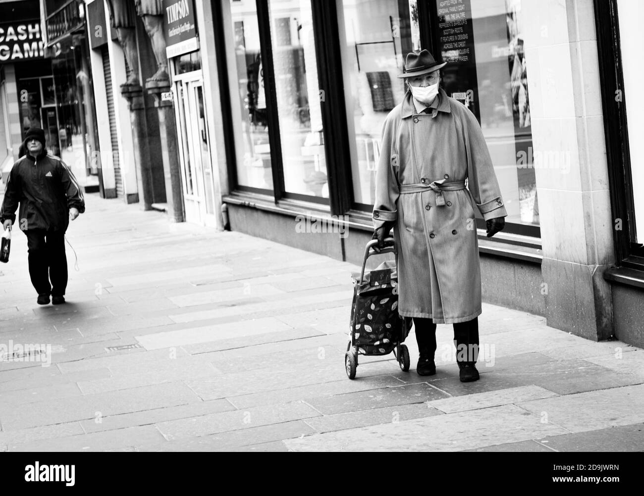 Mann mit Maske, Glasgow Lockdown, Mann trägt eine Maske beim Einkaufen in Glasgow während der covid Pandemie 2020 Stockfoto
