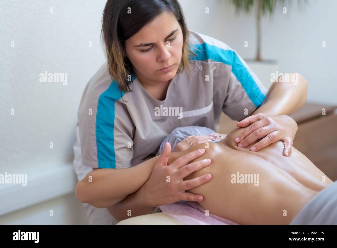 Massage der Wirbelsäule und Schultern. Physiotherapie-Konzept. Stockfoto
