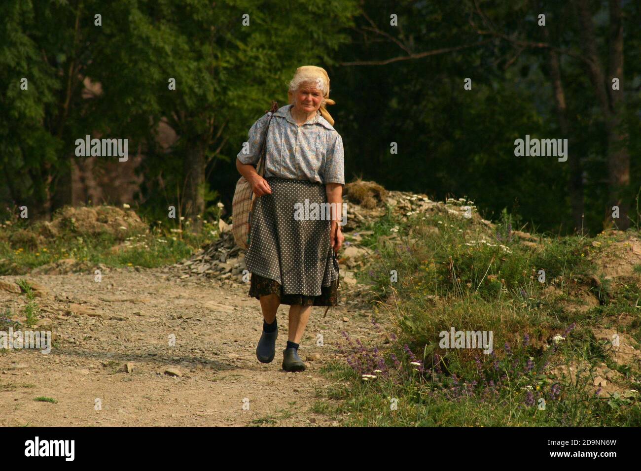 Ältere Frau auf einem Dorfweg in Rumäniens Land Stockfoto
