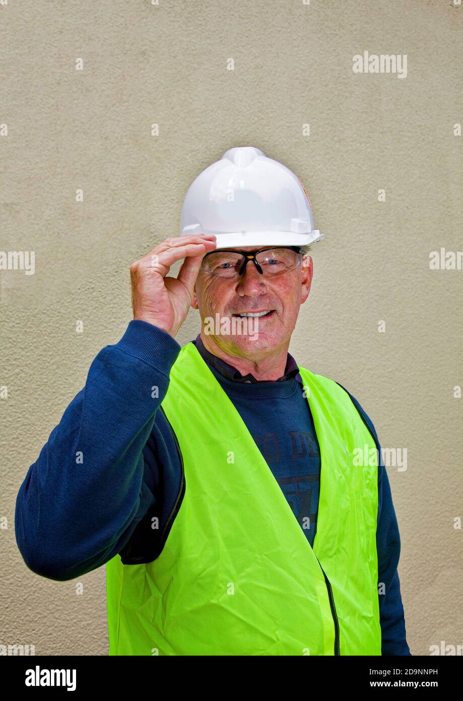 Australischer Bauarbeiter trägt in Canberra geeignete Sicherheitsausrüstung einschließlich Schutzhelm, Fluorweste und Schutzbrille Stockfoto