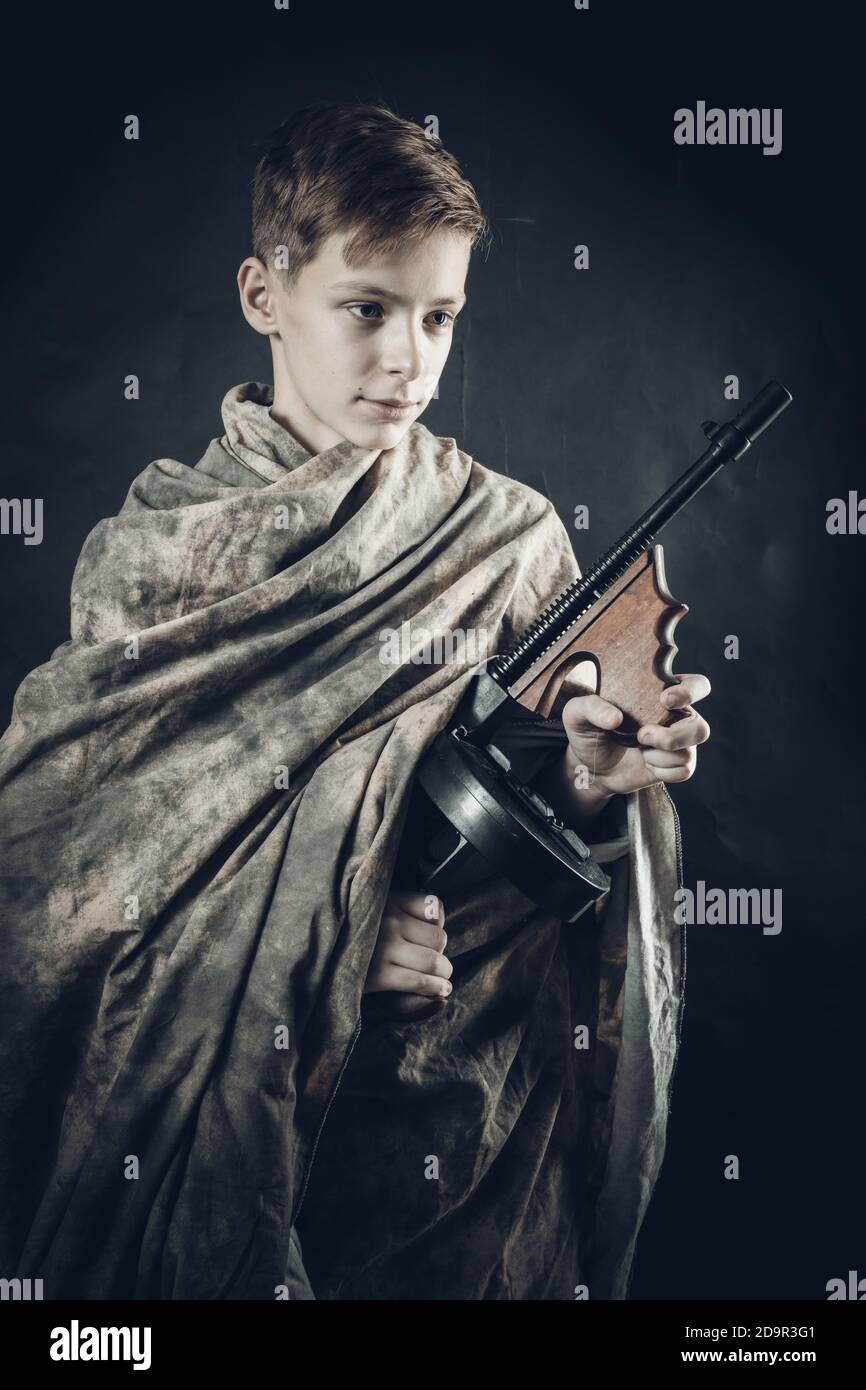 Tenn Junge in Tarnmantel mit einer Waffe spielen gekleidet Soldier Studio Portrait Stockfoto