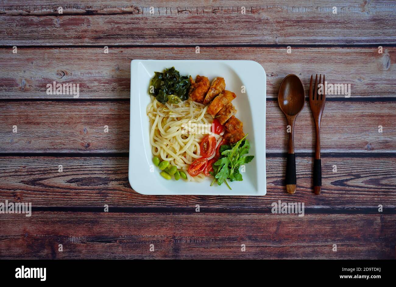 Japanischer Salat mit udon-Nudeln, Huhn, Spinat, Edamame (Soja) Bohnen und Gemüse. Stockfoto