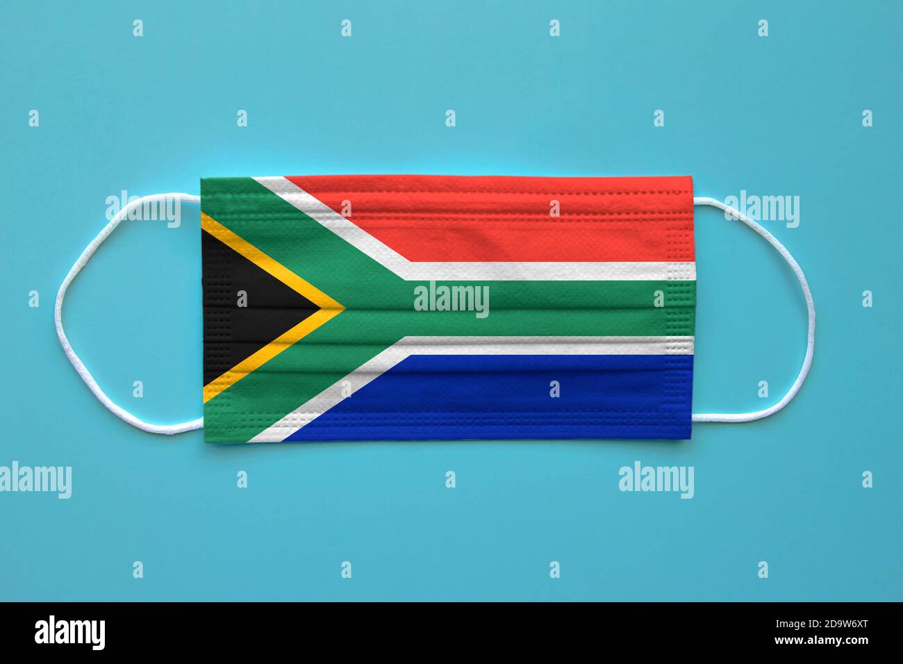 Eine Gesichtsmaske mit südafrikanischer Flagge auf klarem Hintergrund. Konzept: Südafrika während der Pandemie. Stockfoto