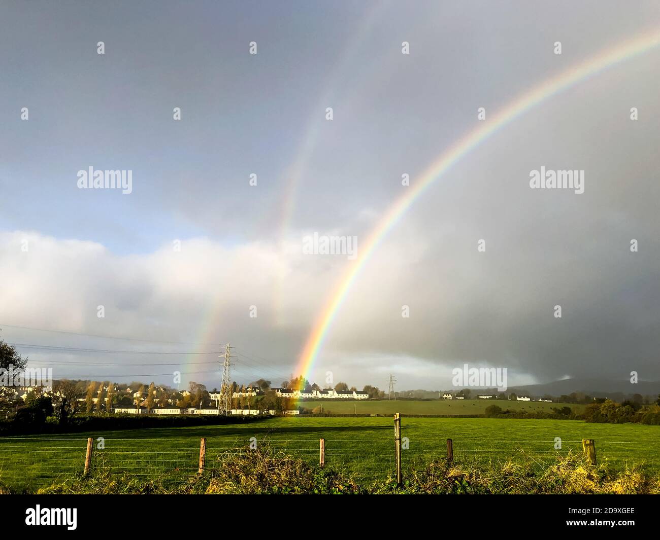 Seltenes natürliches Vorkommen von drei simultanen Regenbögen, die in der aufgenommen wurden Irische Landschaft Stockfoto