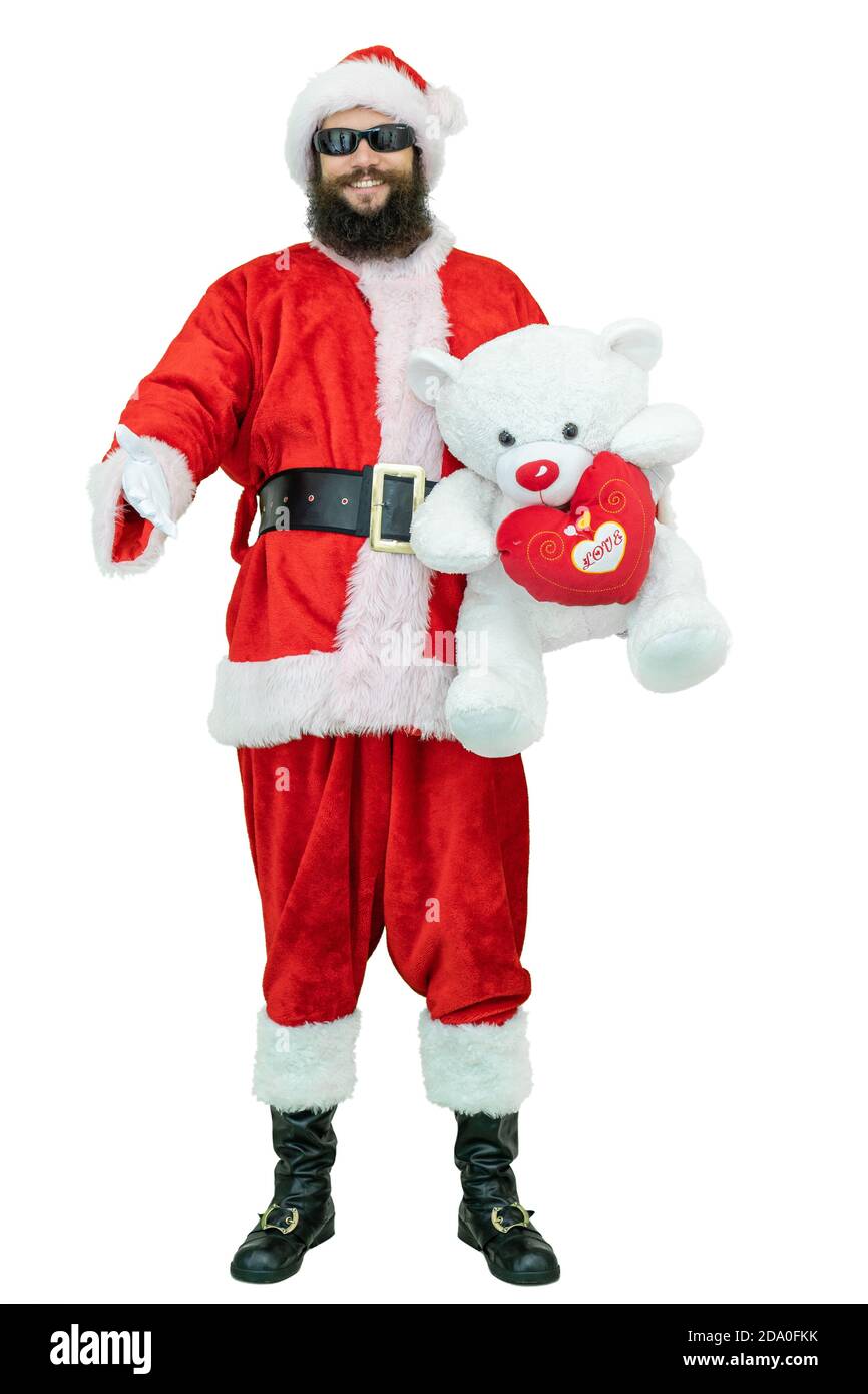 Weihnachtsmann mit Teddybär. Arabischer junger Weihnachtsmann mit schwarzem Bart hält Teddybär auf weißem Hintergrund. Weihnachten steht bevor Stockfoto