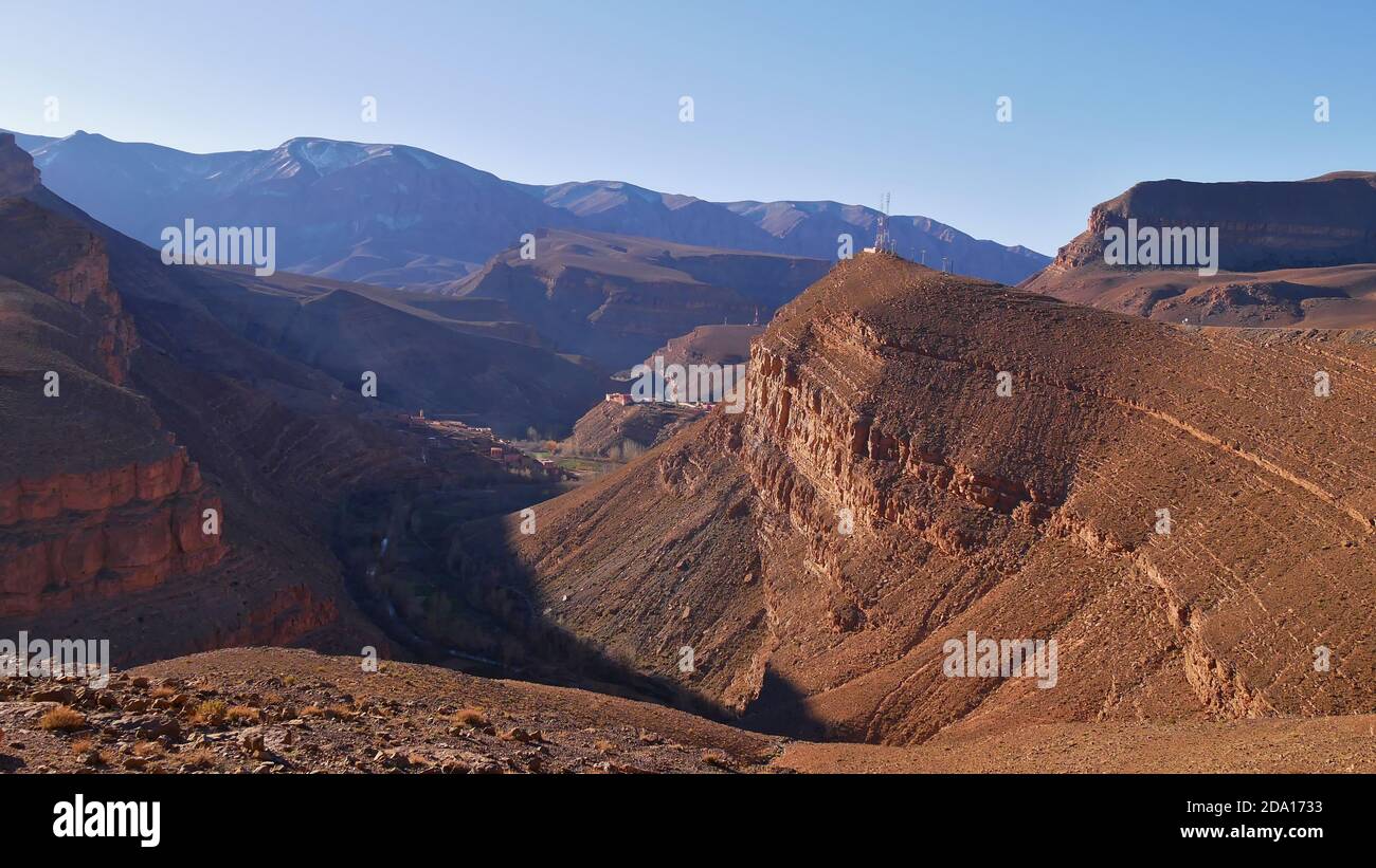 Panoramablick auf die Schluchten des Dadès im südlichen Atlasgebirge mit einem Dorf und einem Antennenturm bei Boumalne Dadès, Marokko, Afrika. Stockfoto