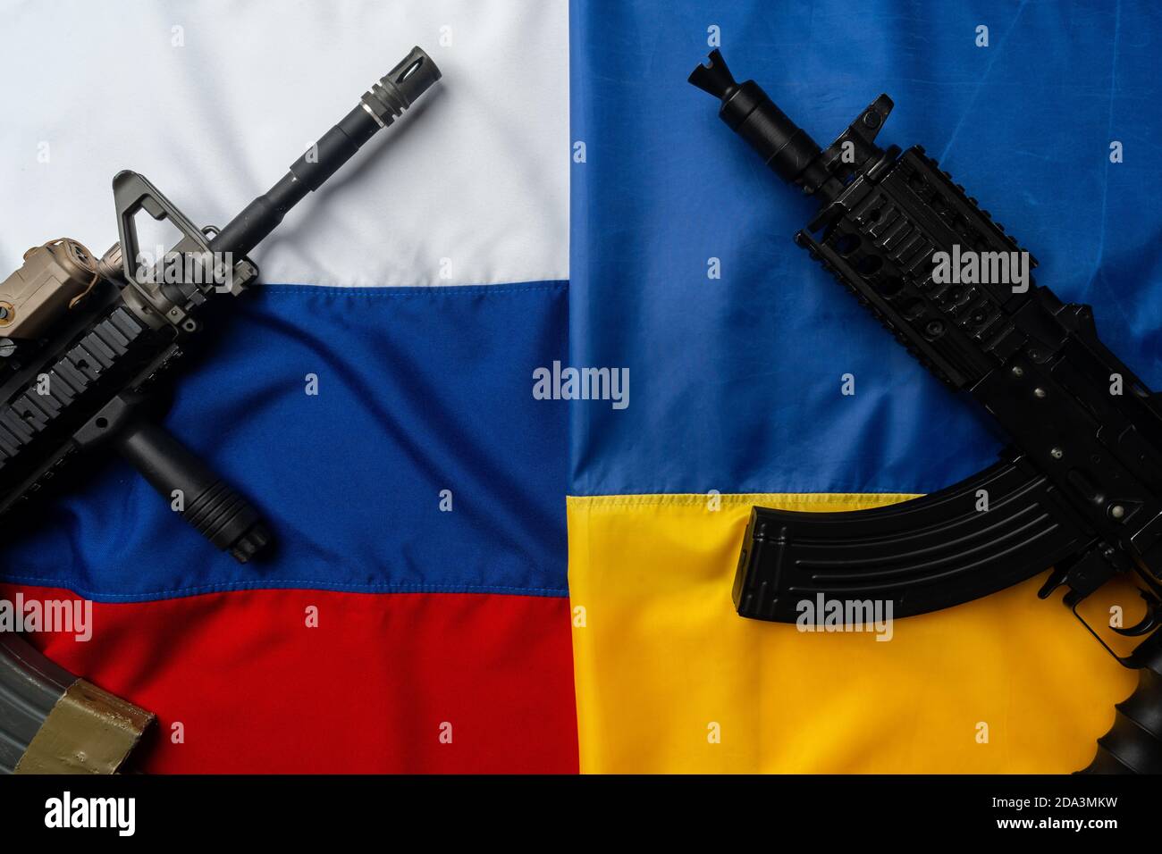 Flaggen von Russland und der Ukraine gefaltet zusammen mit Gewehr Stockfoto
