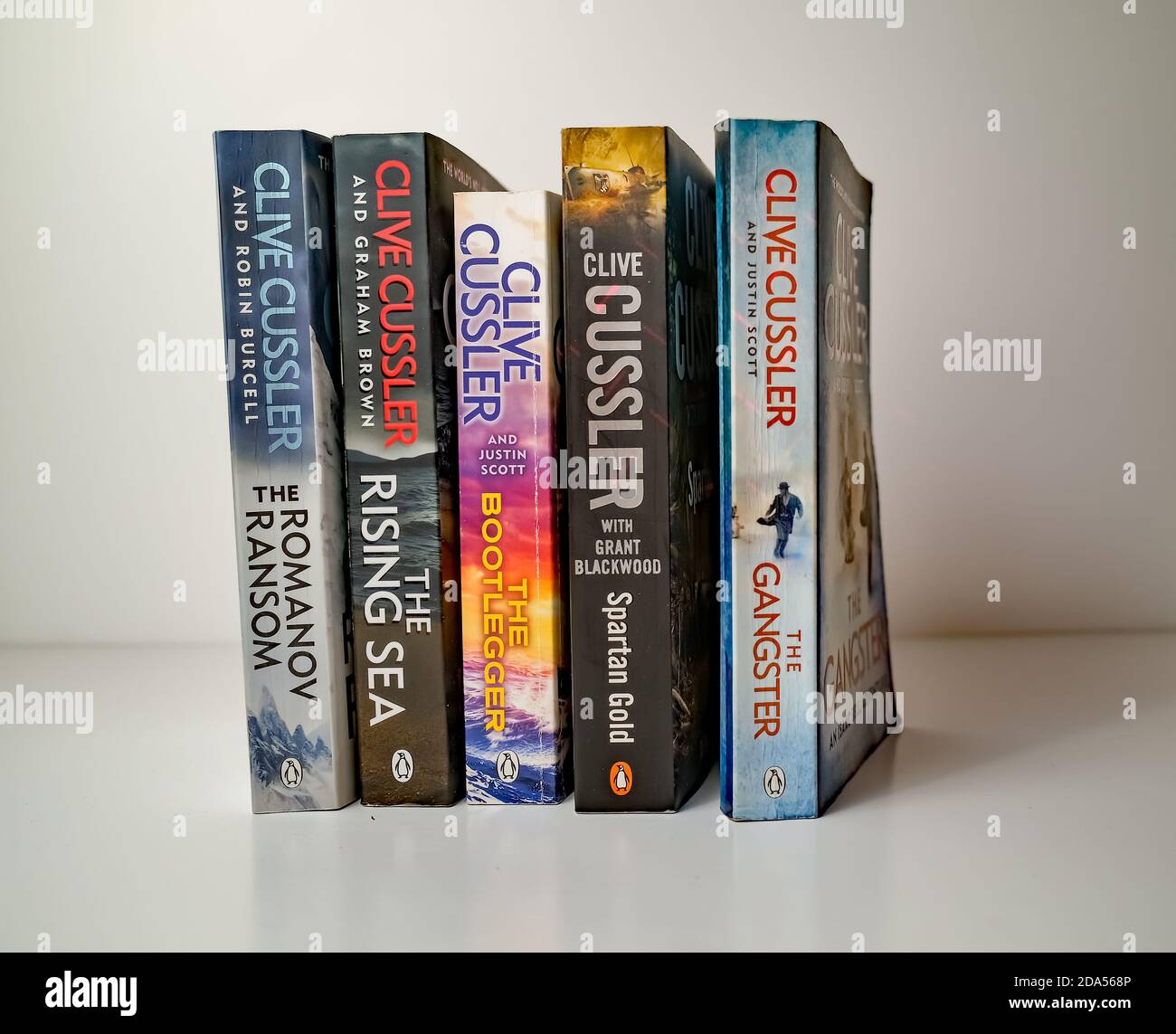 Norwich, Norfolk, Großbritannien – November 08 2020. Illustrative redaktionelle Foto einer Auswahl von Thriller Genre Taschenbuch Bücher von Clive Cussler isolat geschrieben Stockfoto