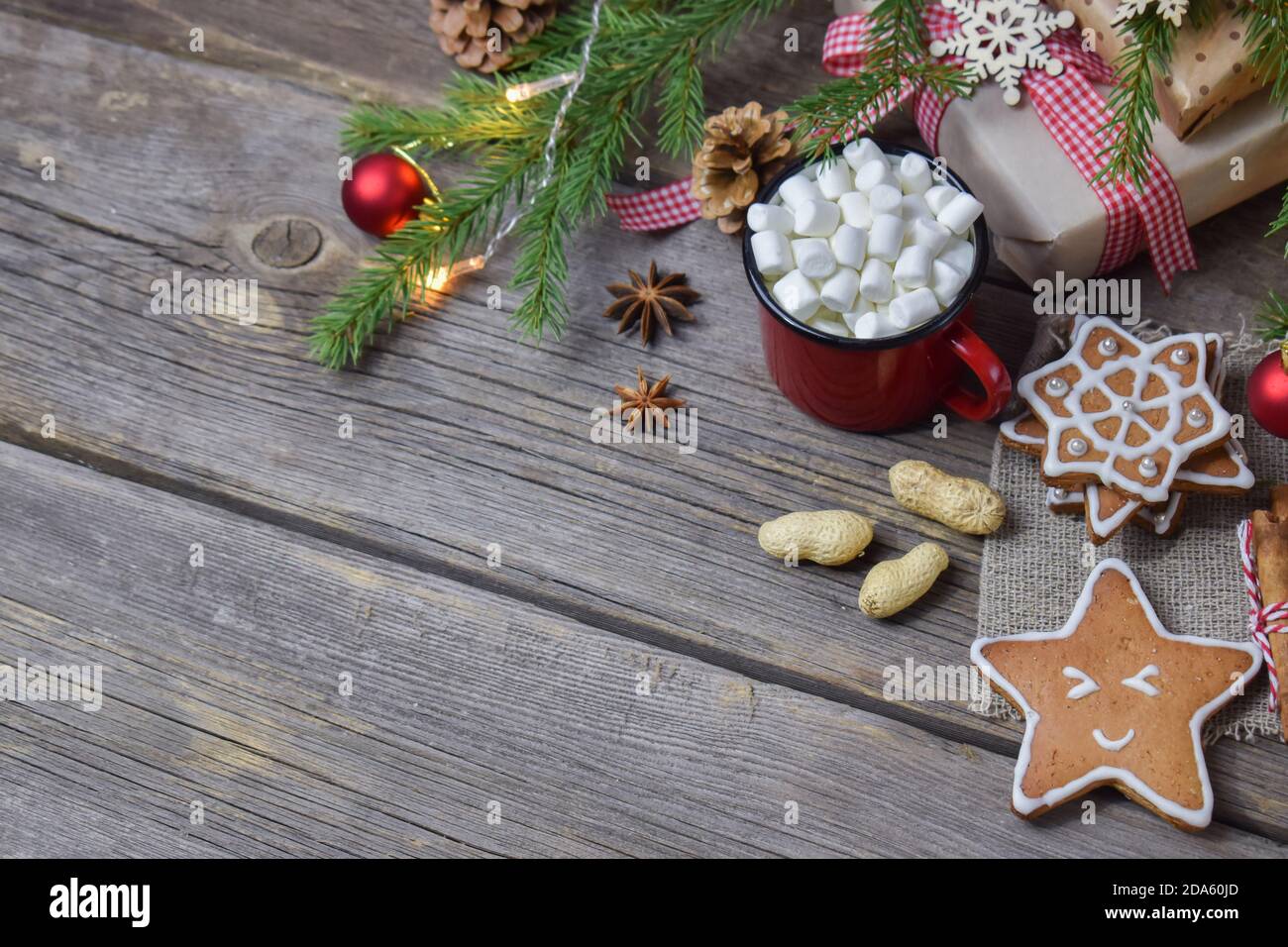 Weihnachtliche Holzuntermalung mit einem Becher heißen Getränks und einem Tannenzweig. Frohe Weihnachten und Neujahr. Stockfoto