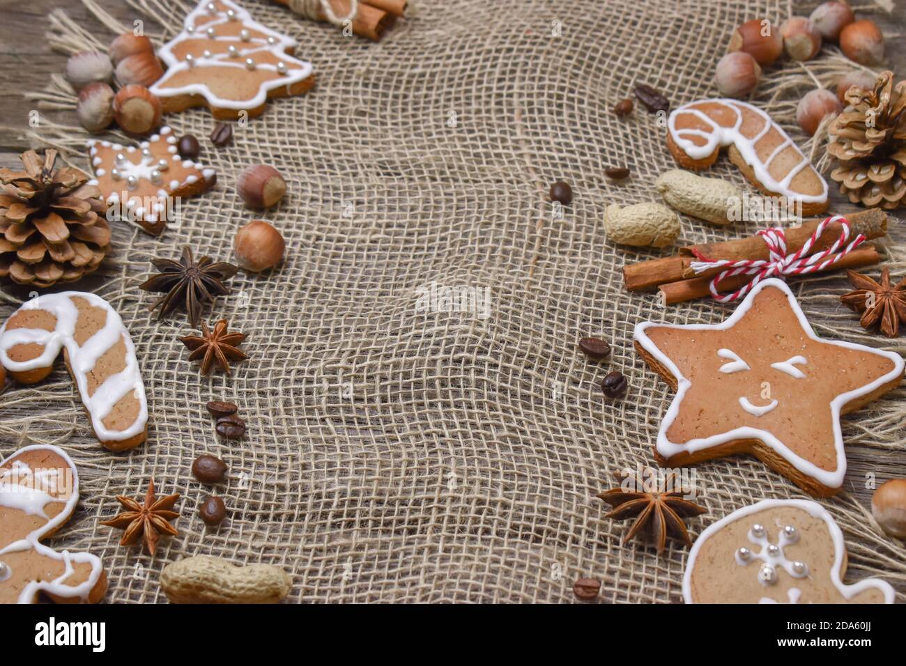 Holzhintergrund mit Weihnachtskeksen und Nüssen gibt es Platz für Text. Stockfoto