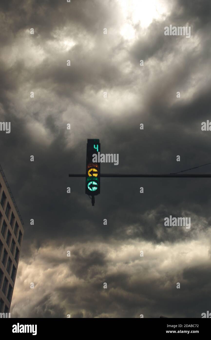 Stadtsturm, Verkehr, dramatische Wolken als Hintergrund, gelbes Licht Stockfoto