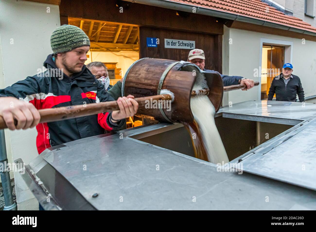 Die Hausbrauer sammeln ihre ursprüngliche Würze aus der Zoigl Brauerei in ihren eigenen Tanks in Falkenberg, Deutschland Stockfoto