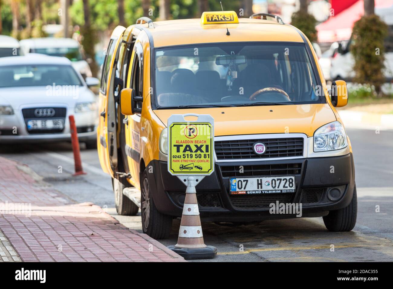 Alanya, Türkei-ca. Okt, 2020: Gelbe Kabine steht auf dem speziellen Parkplatz für Taxiwagen. Transporter mit geöffneten Türen wartet auf Passagiere. Taxi Stockfoto