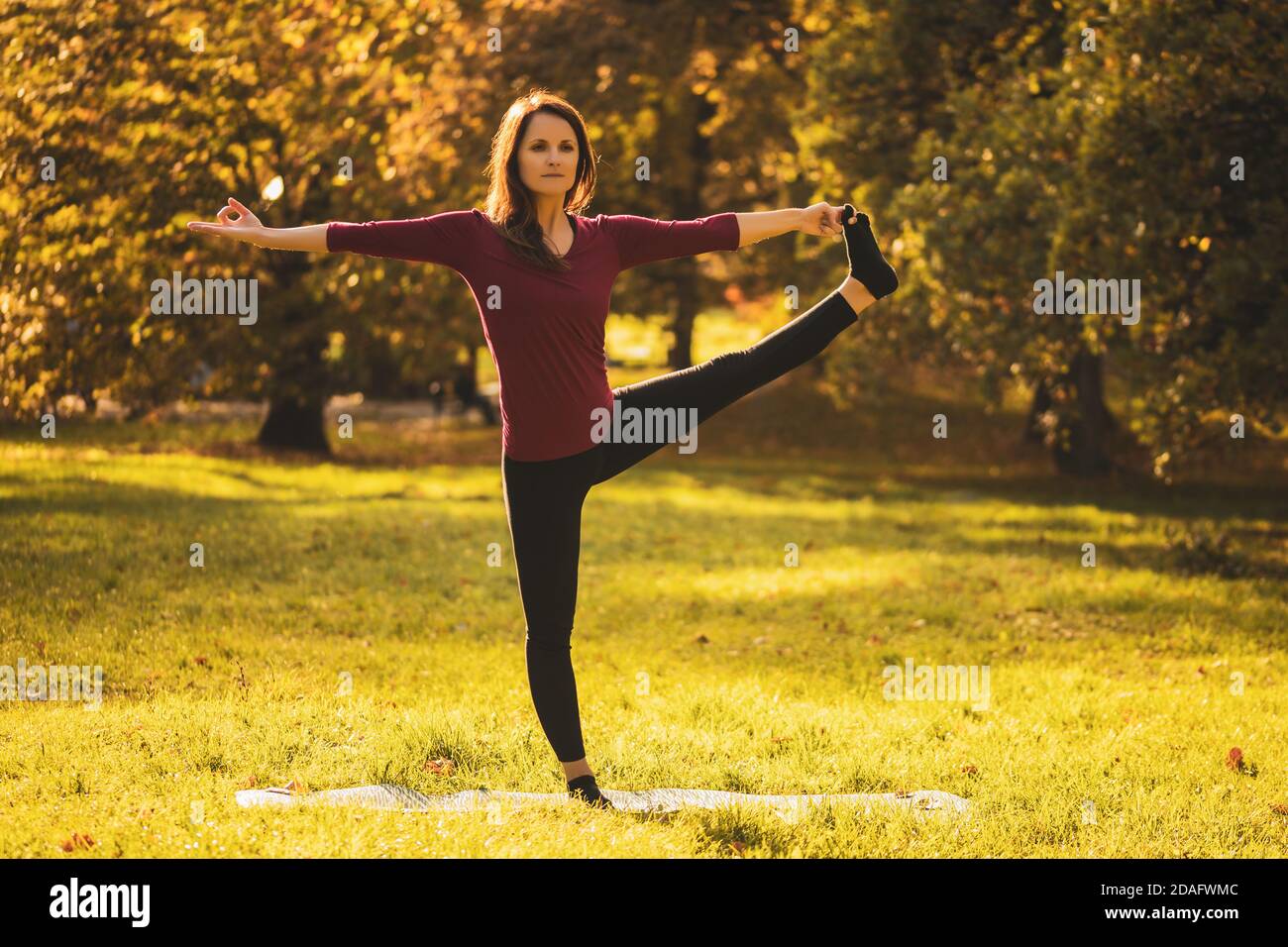 Schöne Frau, die Yoga in der Natur macht,Utthita Hasta Padangustasana /Hand Zu großer Zehe Pose Stockfoto