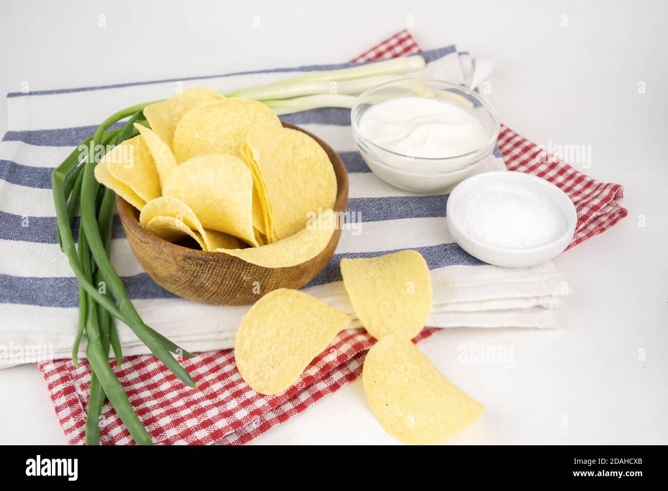 Pommes in einer Holzschüssel mit Sauerrahm und grüner Zwiebel. Stockfoto