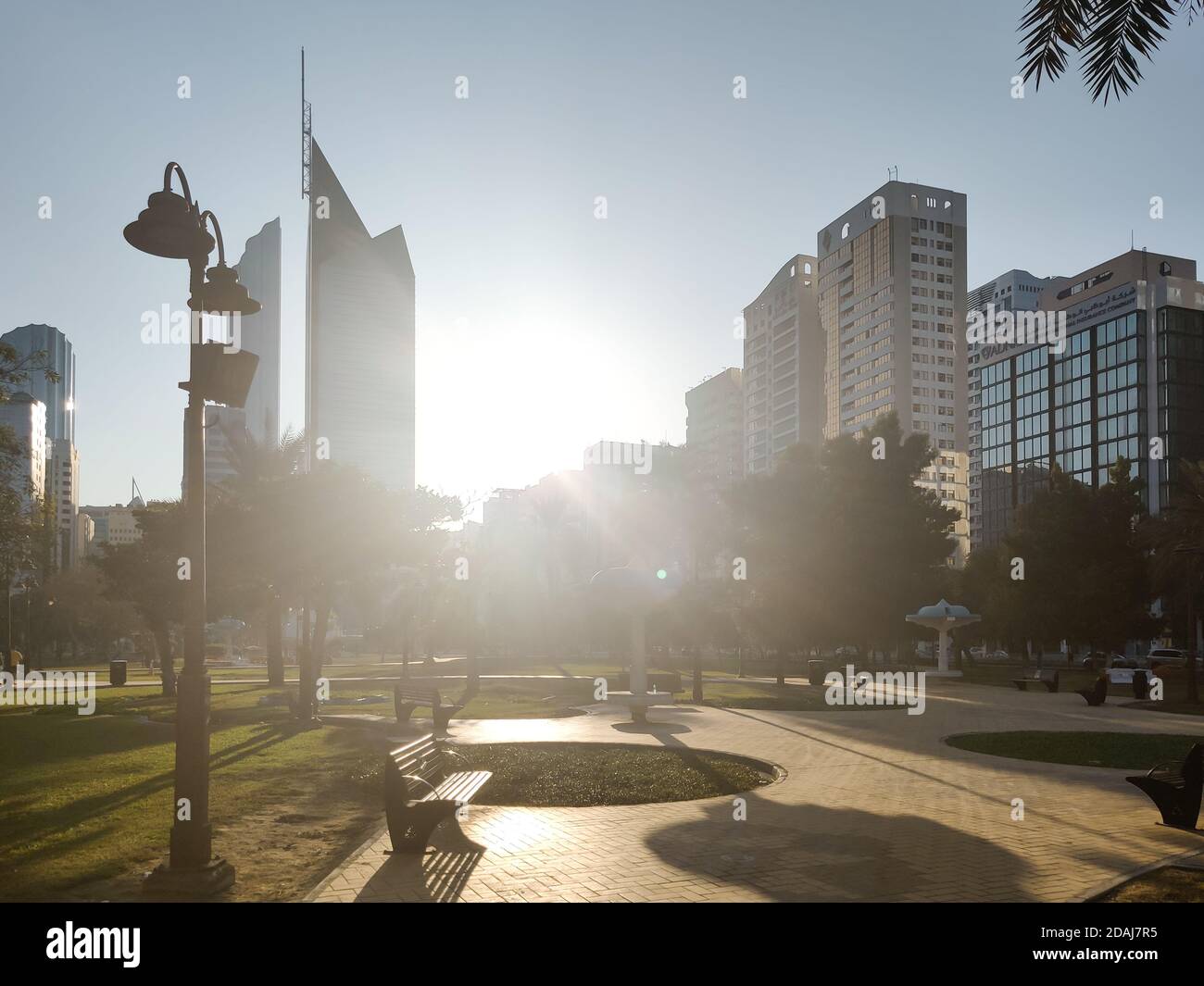 Berühmter Stadtpark von Abu Dhabi in der Innenstadt - wunderschön modern parkszene bei Sonnenuntergang umgeben von Wolkenkratzern - stressfrei Anzeigen Stockfoto