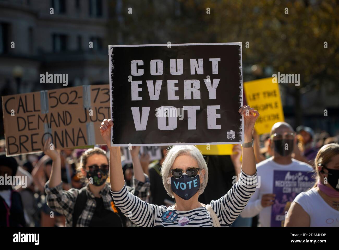 Copley Square, Boston, Massachusetts, USA, 7. November 2020. Eine Reihe von Gemeinschaftsorganisationen versammelten sich, um den Schutz der Demokratie zu fordern und jede Stimme bei den Wahlen 2020 zu zählen. Foto zeigt eine Frau mittleren Alters mit Schild während der Demonstration. Alle bei der Demonstration waren verpflichtet, eine Gesichtsbedeckung oder Maske zu tragen und nach Möglichkeit soziale Distanz zu erreichen. Stockfoto