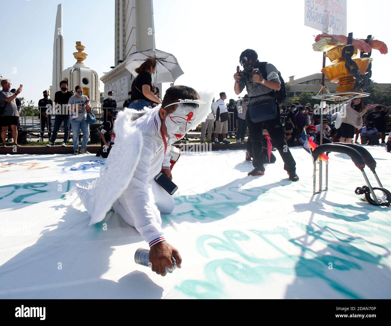 Bangkok, Thailand. November 2020. Ein prodemokratischer Protestierender schreibt während der Demonstration auf einem großen weißen Blatt vor dem Boden: Tausende von prodemokratischen Demonstranten gingen auf die Straße zum Democracy Monument und forderten den Rücktritt des thailändischen Premierministers und die Reform der Monarchie. Kredit: SOPA Images Limited/Alamy Live Nachrichten Stockfoto