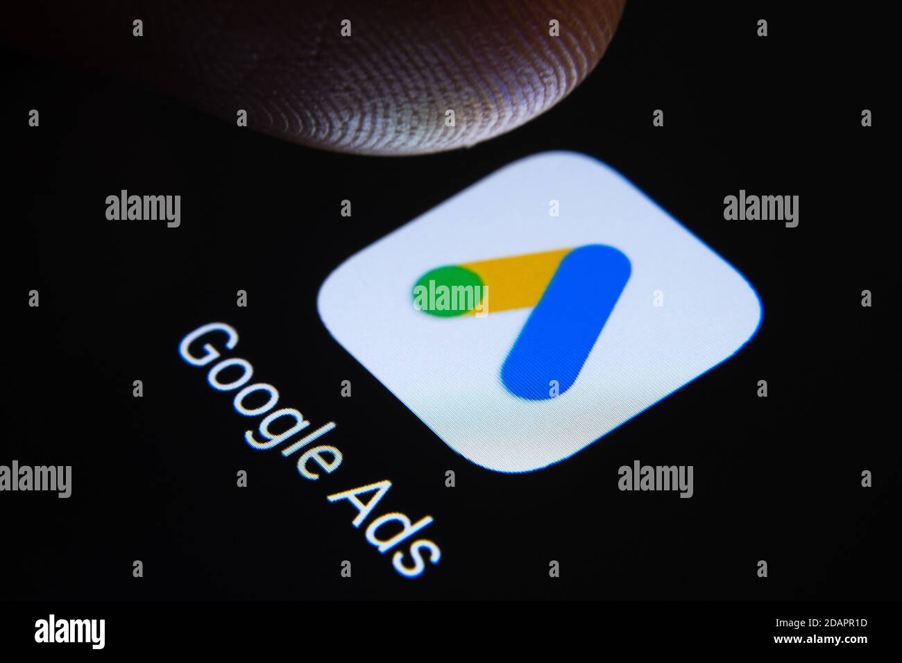 Stafford / Vereinigtes Königreich - November 12 2020: Google Ads App und verschwommene Fingerspitze darüber bereit, den Bildschirm des Smartphones zu drücken. Stockfoto