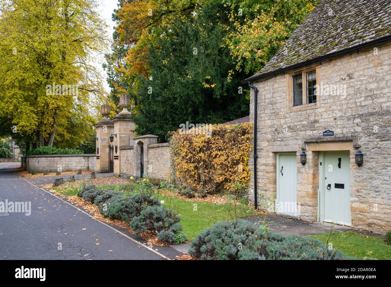 Cotswold Steinhaus und der Eingang zum Slaughtes Herrenhaus im Herbst. Weniger Schlachten. Cotswolds, Gloucestershire, England Stockfoto