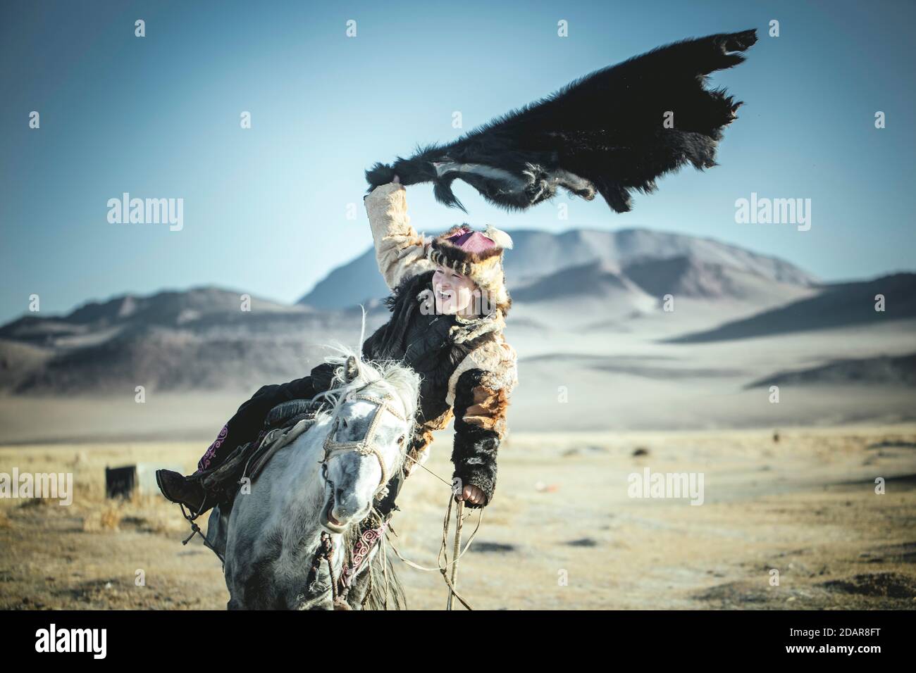 Junger Adlerjäger trainiert für den nächsten Buzkaschi-Wettbewerb, Reitspiel, Olgii, Mongolei Stockfoto