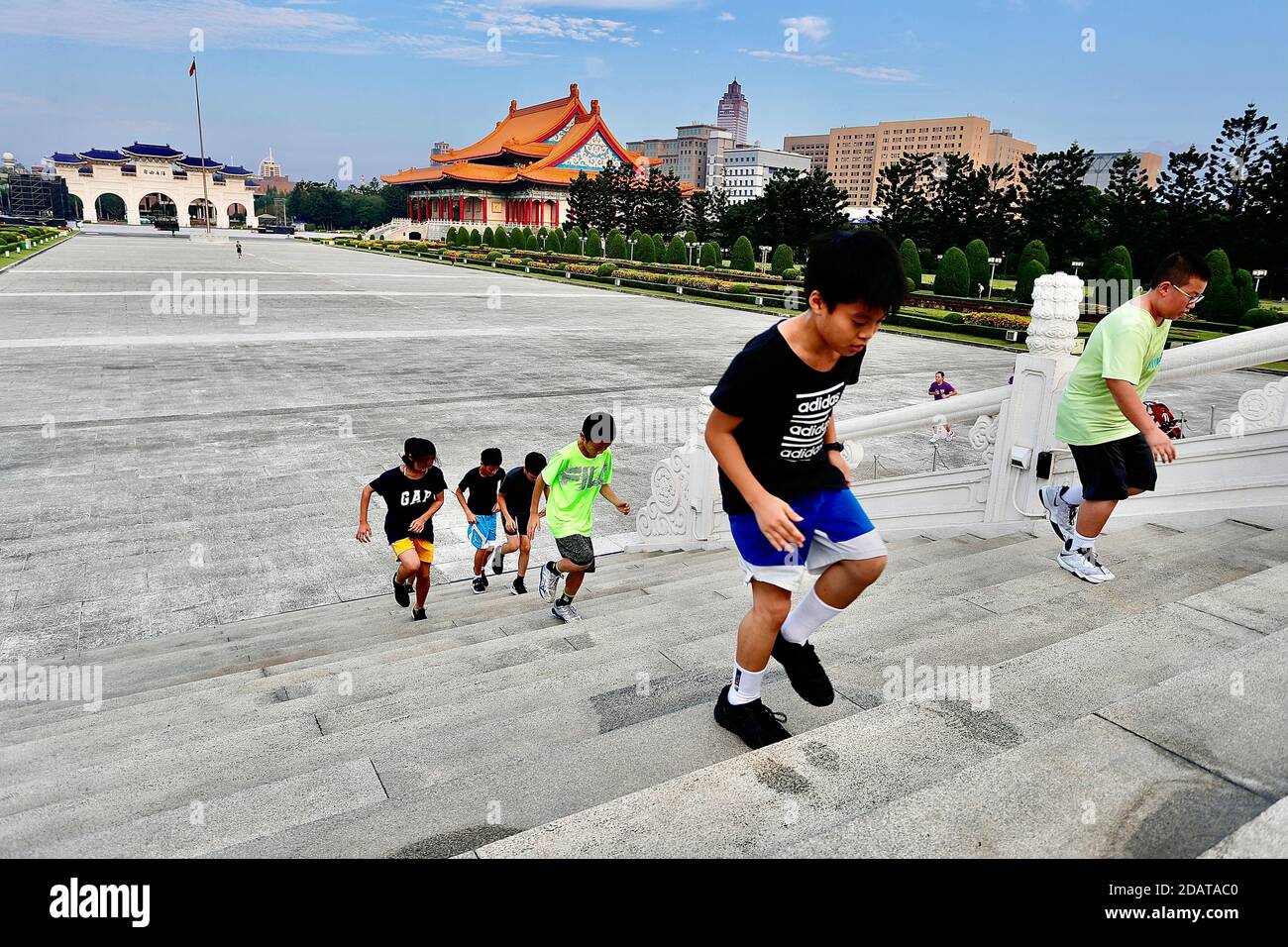 Eine Gruppe von Kindern wird beim Treppentraining für den Outdoor-PE-Kurs  auf dem Liberty Square der Chiang Kai-Shek Memorial Hall beobachtet, da  Taiwan mit Adipositas konfrontiert ist.Laut einer Studie haben Erwachsene,  die als