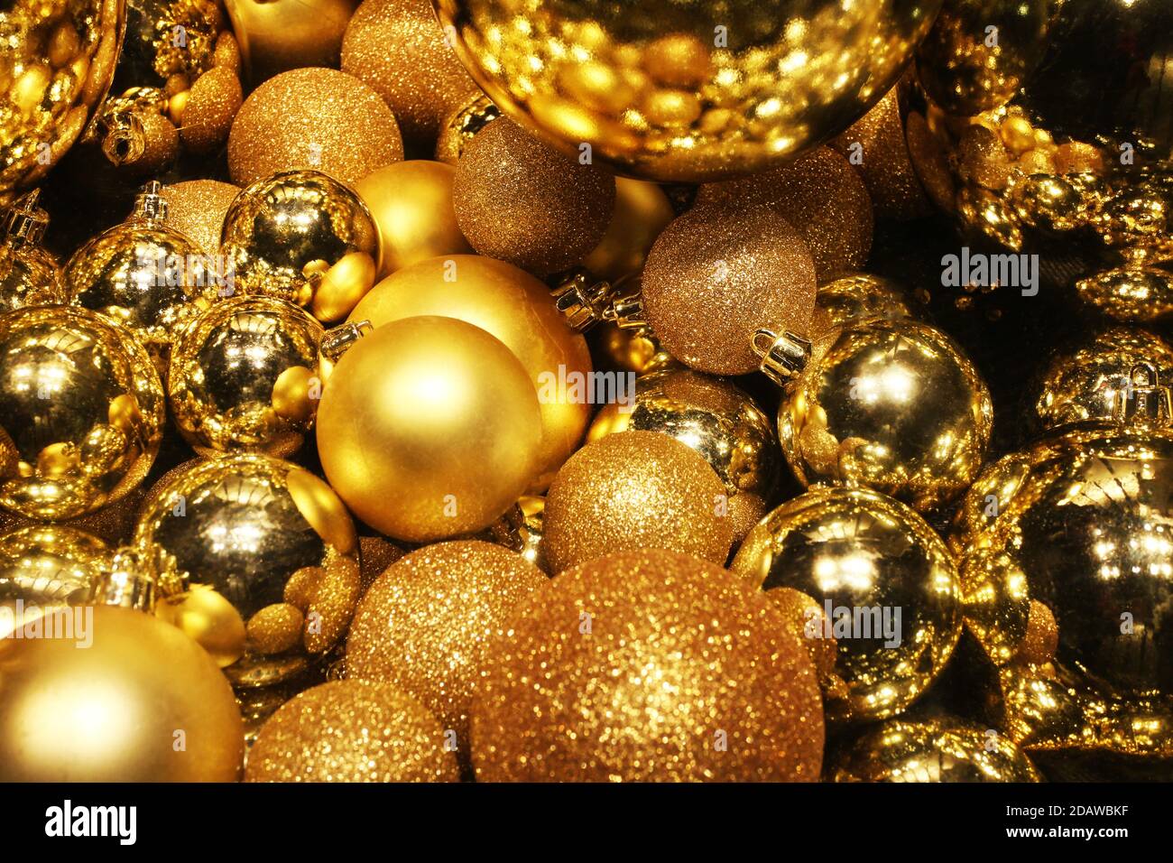 goldene Kugeln, festlicher Hintergrund mit Reflexionen und helle Weihnachtsdekoration Stockfoto