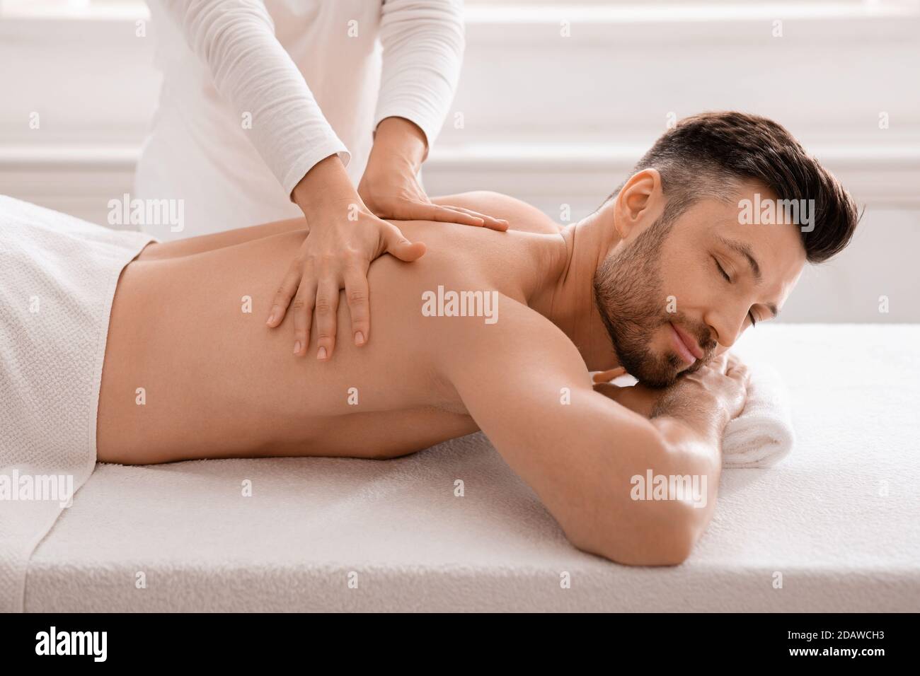 Friedlicher Mann mittleren Alters, der im luxuriösen Spa-Salon war Stockfoto