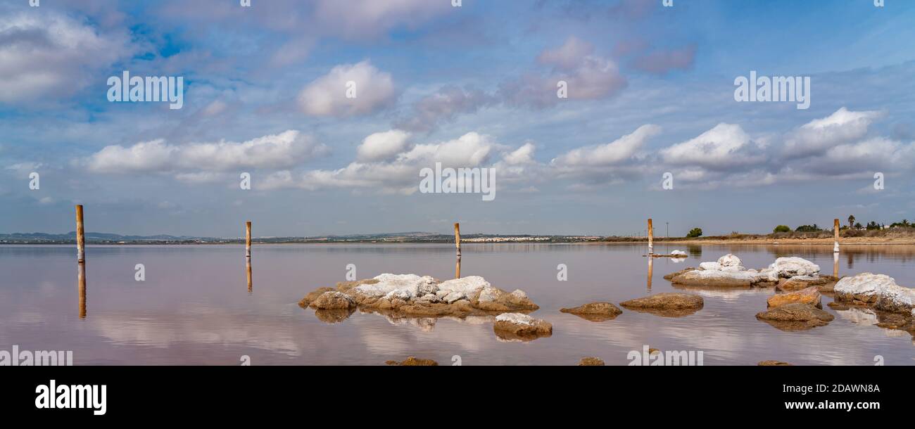 Die Felsen im rosa Salzsee Laguna Rosa, Torrevieja, die Reflexion auf dem Wasser aus den Wolken, das Panorama Stockfoto