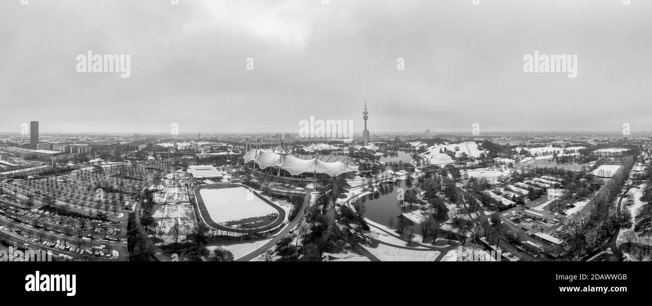 Verschneite Stadt der beliebten Tourismusstadt München im Januar, ein Luftüberblick im Winter in schwarz-weiß. Stockfoto